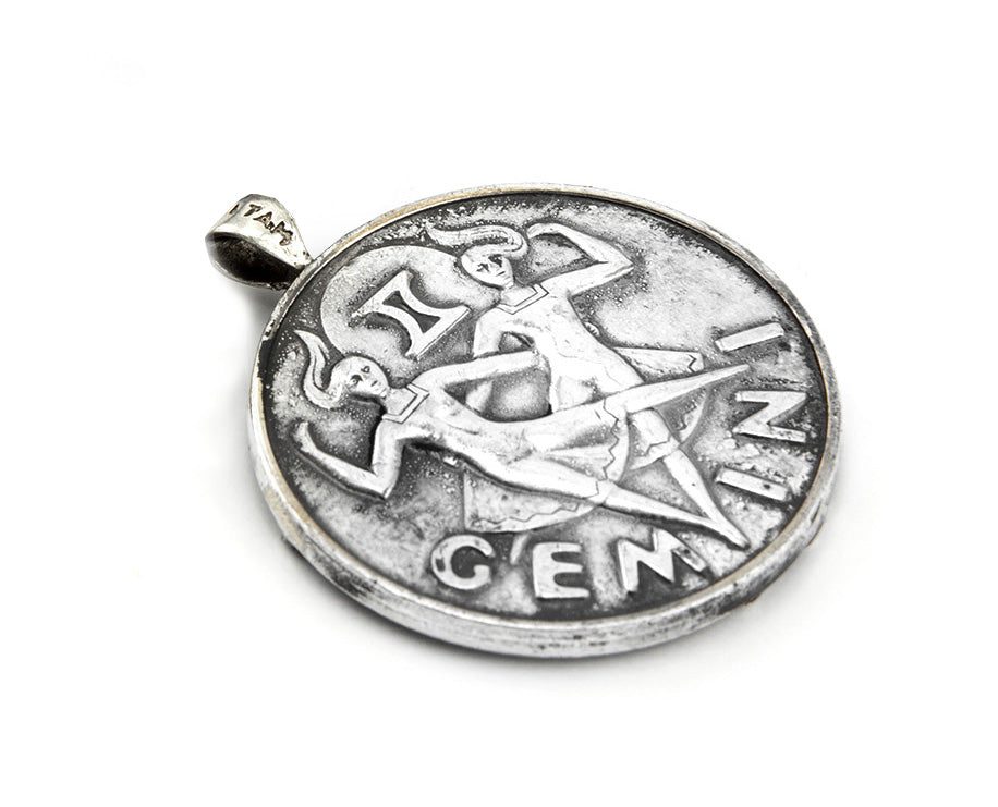 Silver Gemini pendant along with tree and birds