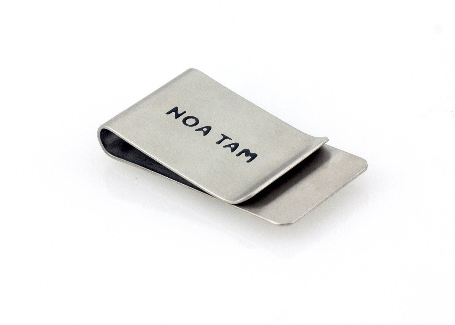 Back of the stainless steel money clip engraved with the Noa Tam signature.